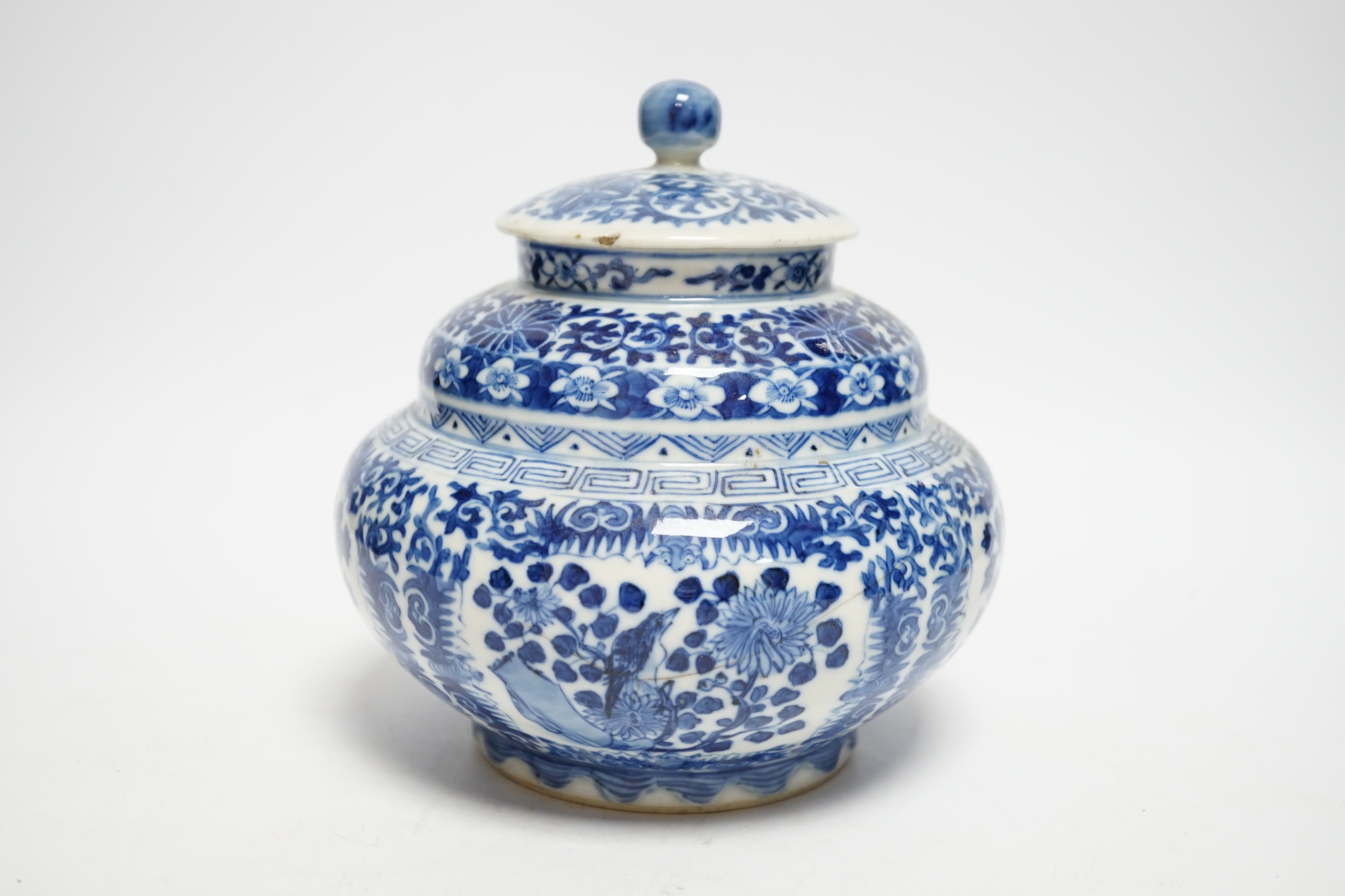 A late 19th century Chinese blue and white floral jar and cover, seal mark, 17cm high
